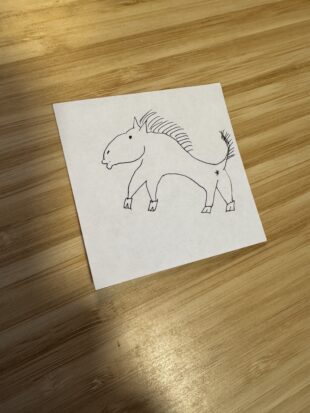 Oh boy. This is a drawing of a horse on a white piece of paper. It is drawn in ink and looks more like Gumby the rubber man than a horse. Its lips make a kissy face, it has a visible butthole, and its hooves look like little shoes instead of a part of its body. There was minimal consideration for a horse's need for bones in this drawing.